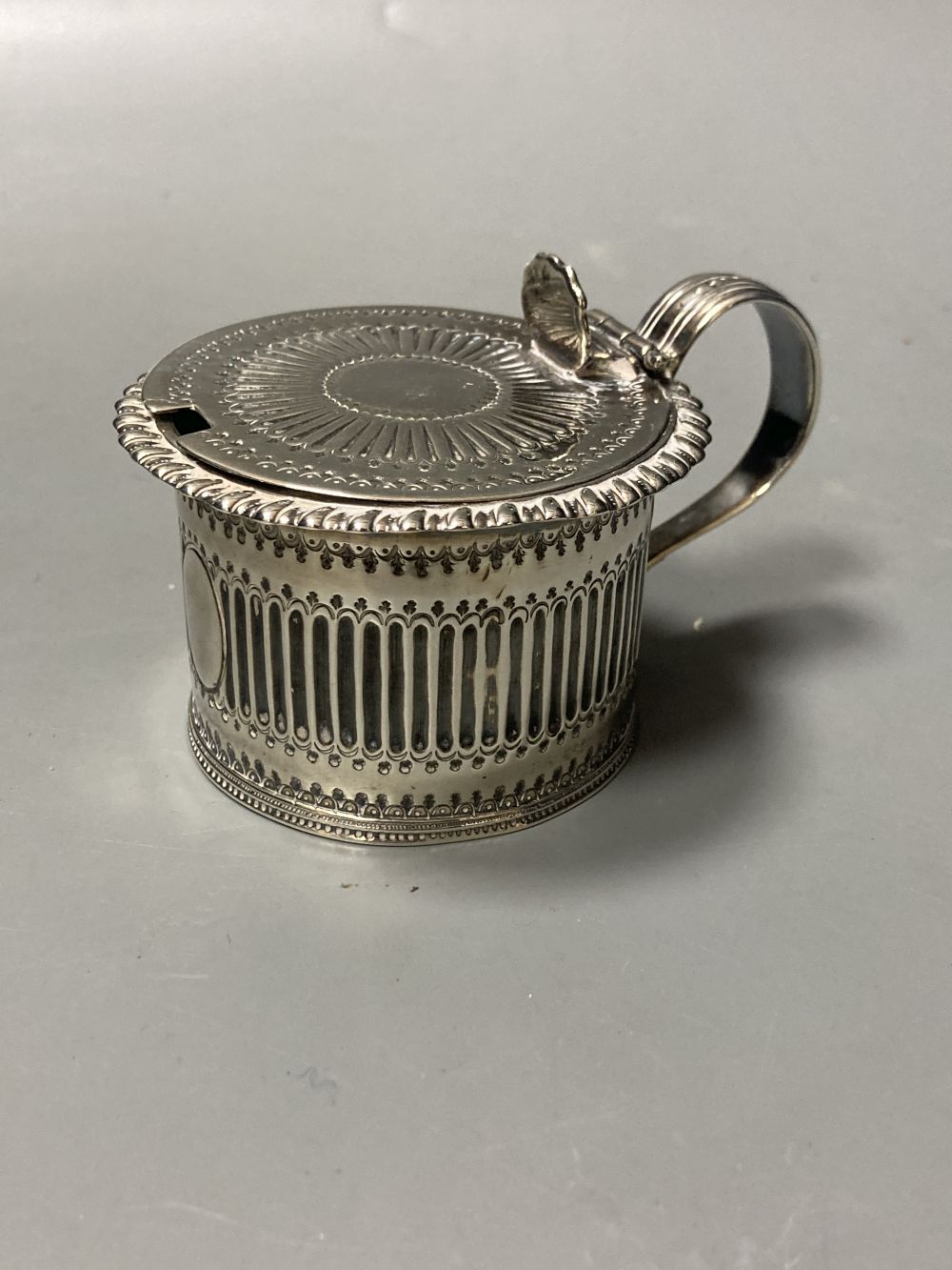 An early George III silver pepperette, with later embossed decoration, Samuel Wood?, London, 1760, 13.9cm, 111 grams.